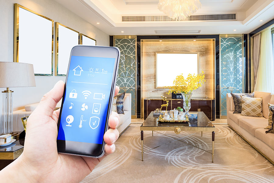 hand holding phone with smart home controls in living room